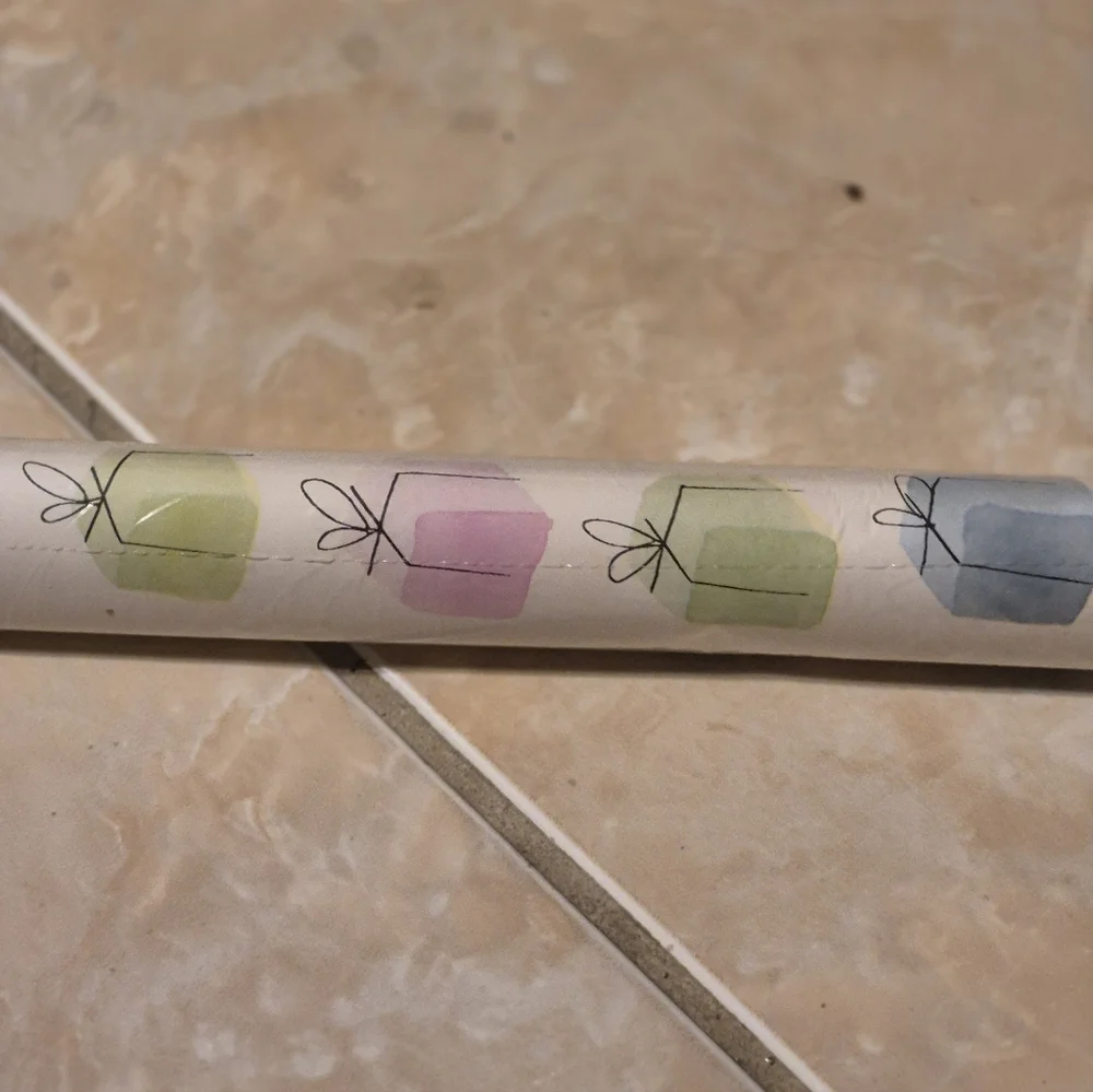 ÖNSKA wrapping paper from IKEA.  In a multi colored with white background in a c